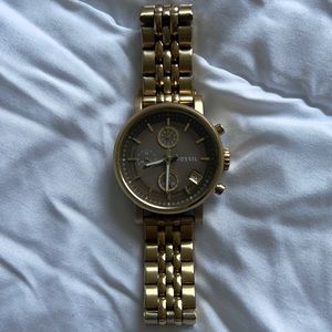 Gold women’s Fossil watch.